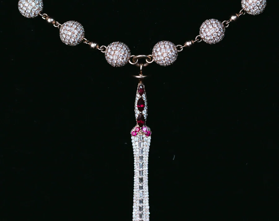 A Royal T diamond blade pendant on a beaded chain