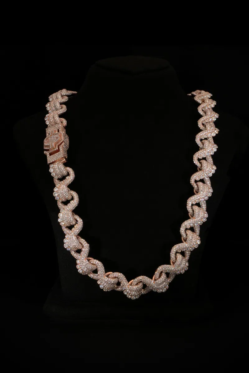 Custom stone-set link chain displayed on a black bust