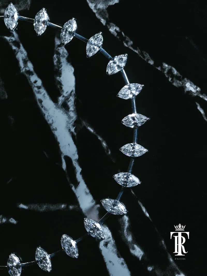Chain of marquise-cut stones on black marble