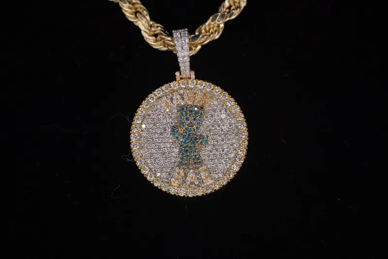 Round pavé medallion with a waving figure in blue stones, on a rope chain