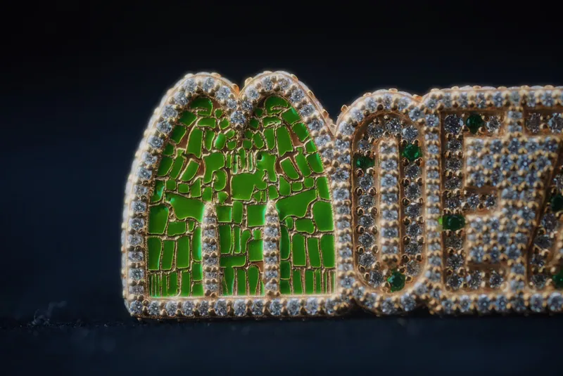 MOEZAIC lettering pendant from a low side angle