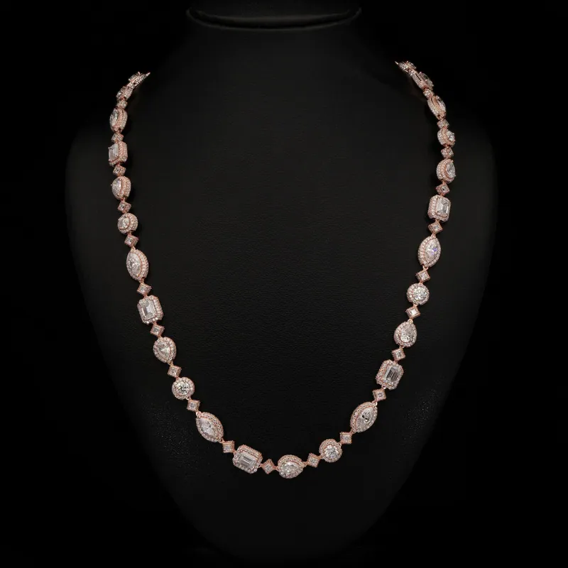 Rose-tone chain with mixed-shape stone-set stations on a black bust